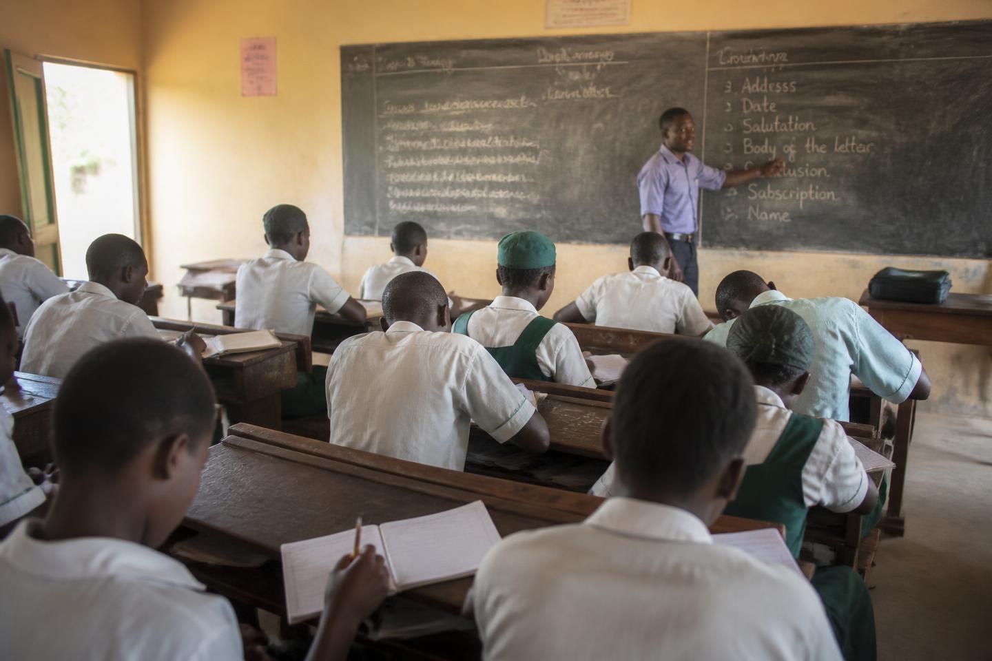 Students seated at desks in a rural Nigerian classroom